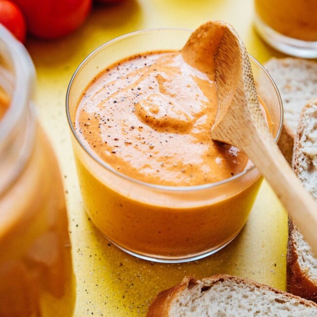 Romesco sauce recipe in a jar with a spoon