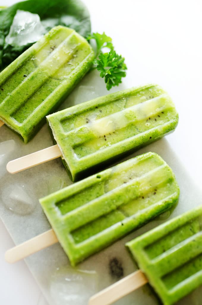 These healthy Green Smoothie Popsicles, with ginger, fruit, and spinach, are a fun and refreshing treat for summer (and they pack in a serving of veggies!)