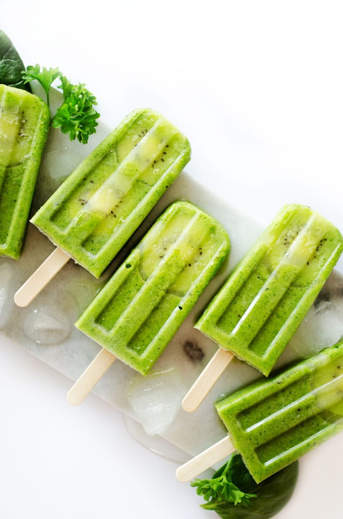 Green popsicles on white background