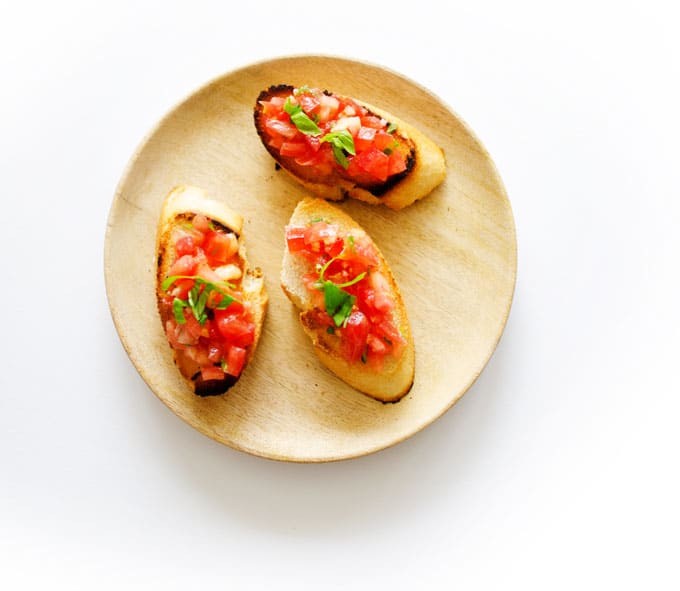 We're whipping up two kinds of bruschetta today: traditional and tomato mango bruschetta! Both are so easy and make the perfect healthy snack!