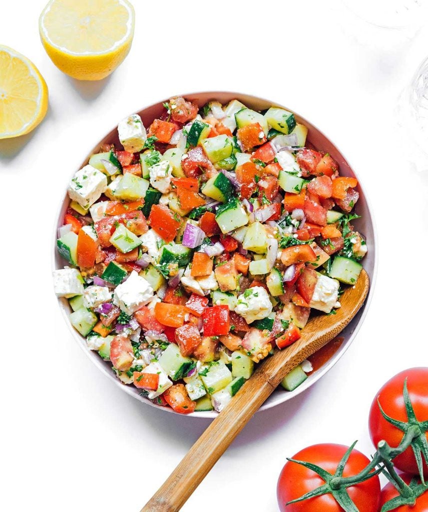 A serving bowl filled with a freshly tossed summer veggie salad