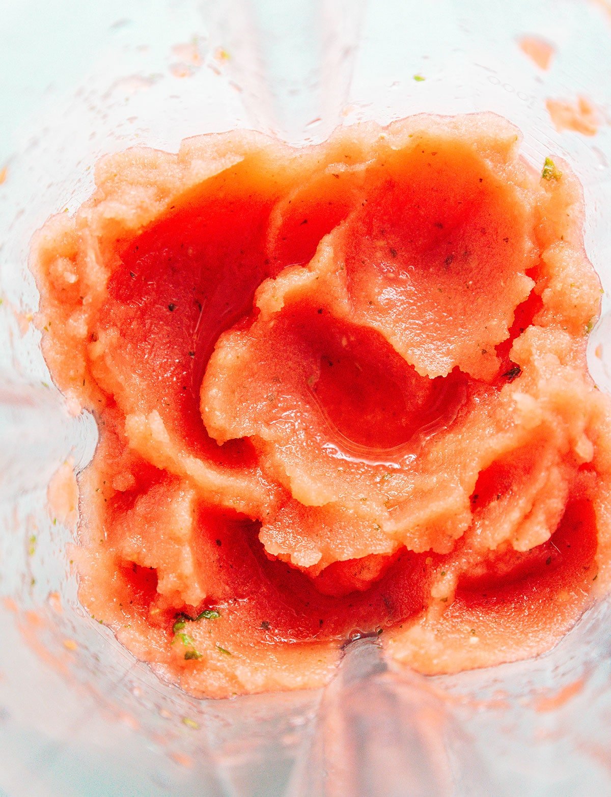 Watermelon smoothie ingredients being blended in a blender.