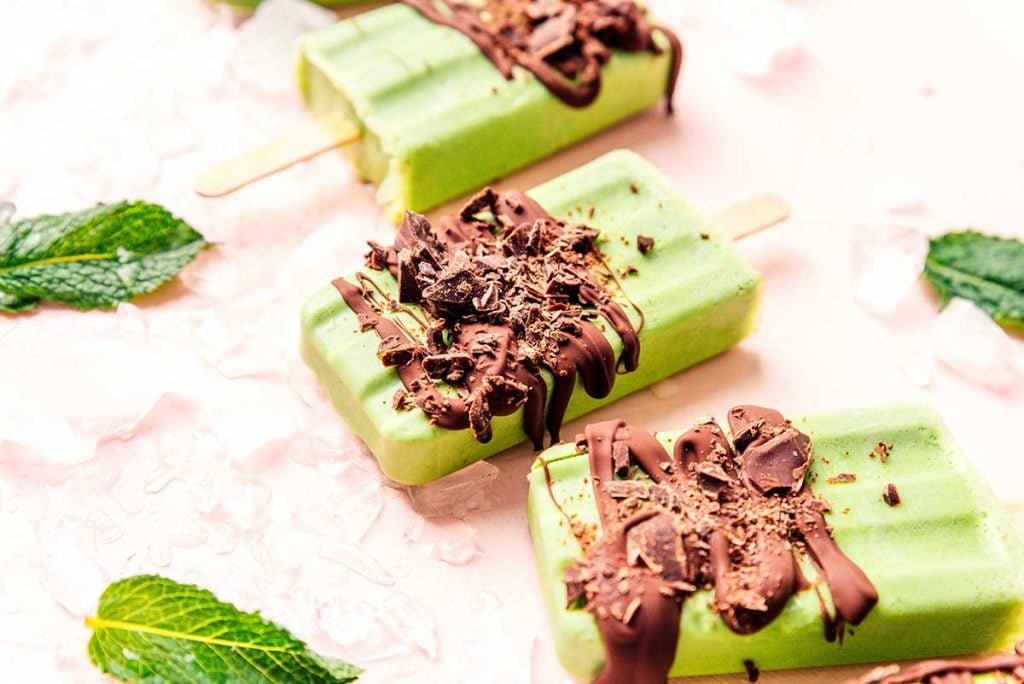Chocolate drizzled on green popsicles
