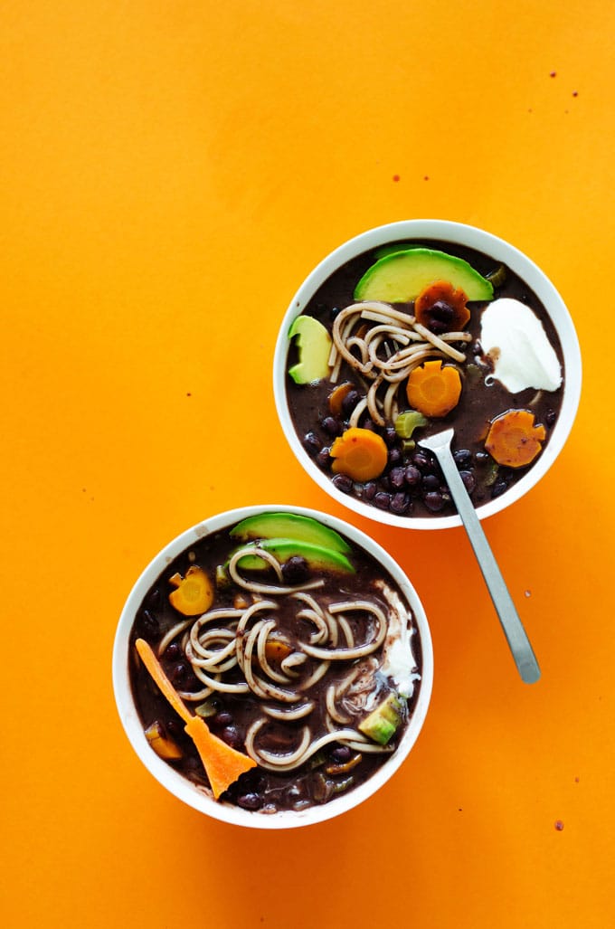 Halloween soup with black beans, udon noodles, and Halloween-shaped vegetables.