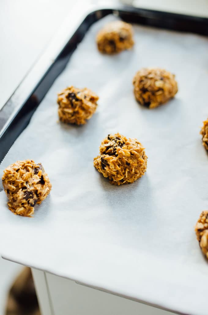 Raw cookie dough balls on a pan - Need a healthy cookie recipe that's just as moist and delicious as your old favorites? This Sweet Potato Cookie recipe with chocolate and oats has you covered.