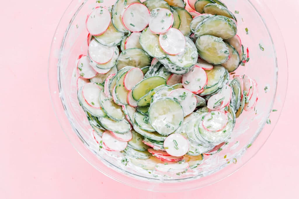 A clear glass bowl filled with spring radish salad