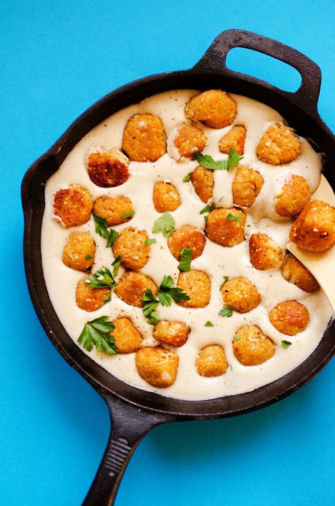 Photo of vegetarian Swedish meatballs in cream sauce in a cast iron skillet