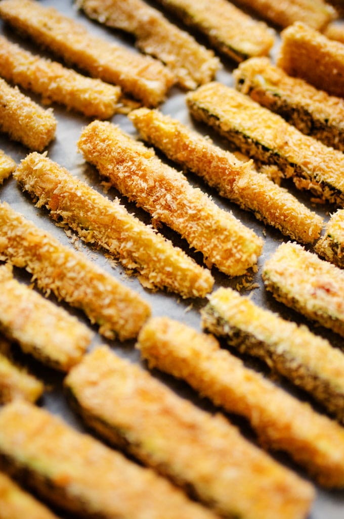 Uncooked zucchini fries on a baking sheet