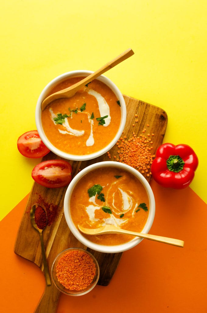 This Roasted Red Pepper Soup draws inspiration from the delicious Spanish pepper sauce, romesco! With smoky roasted peppers, juicy Roma tomatoes, and a dollop of almond butter, this is a creamy soup that gets a delicious dinner on the table (in under 15 minutes!)