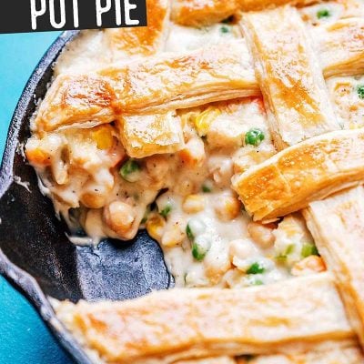 Chickpea pot pie in a cast iron skillet on a blue background