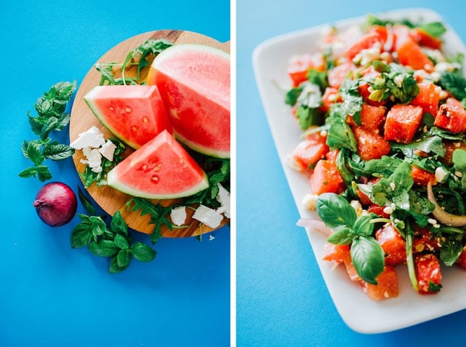 Grilled watermelon salad with arugula, feta cheese, and mint in a bowl on a blue background