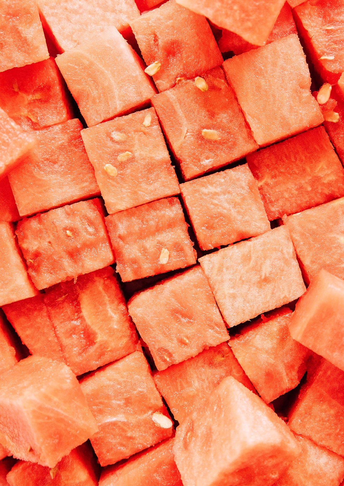 Watermelon cubes close up packed next to eachother.
