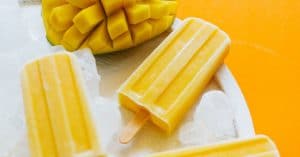 These Mango Lassi Popsicles have it all...the sweet mango, the soft texture, the...kefir? Packed with probiotics and ultra-creamy, kefir is the secret to these refreshing summer pops.