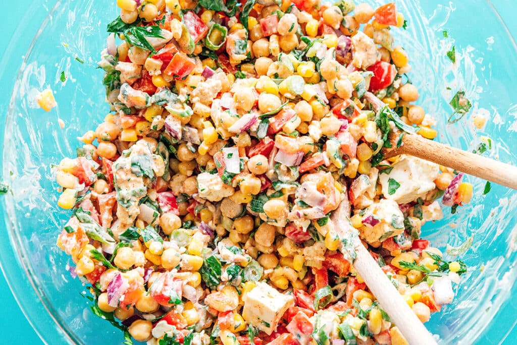 Chickpea corn salad in a bowl with a serving spoon.