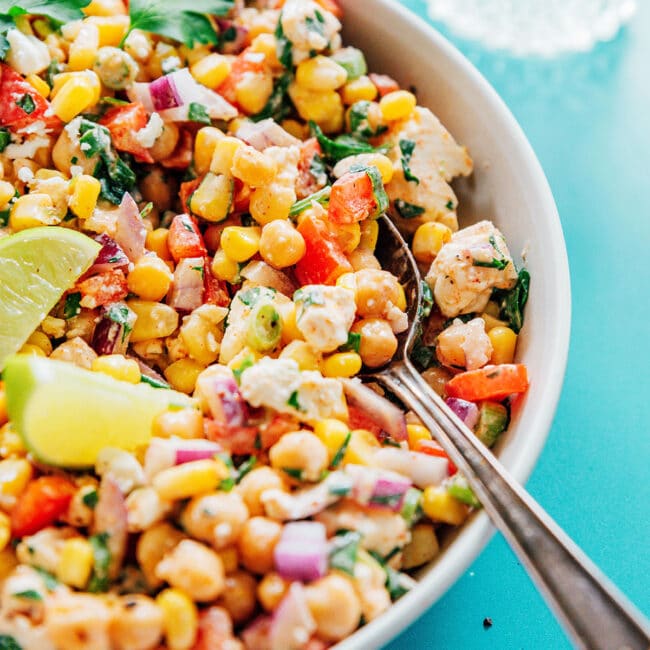 Chickpea corn salad in a bowl with a serving spoon.