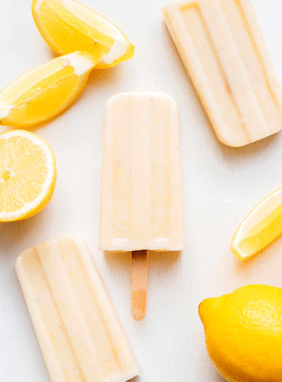 Lemon creamsicles with lemon fruit on a white background