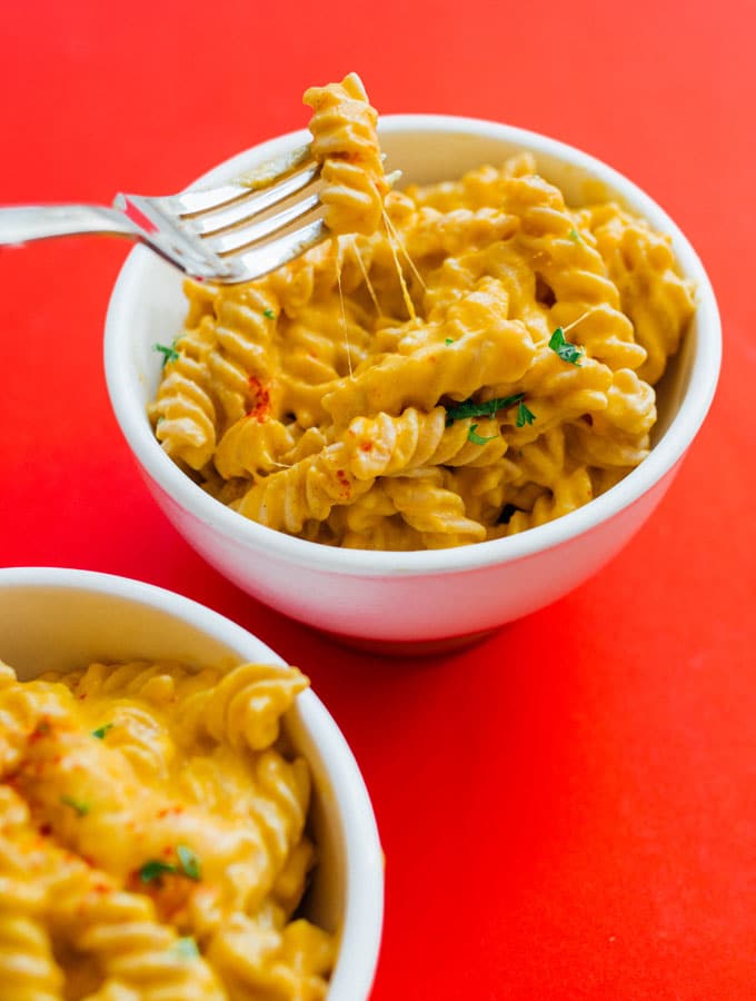 Macaroni and cheese with butternut squash puree on a red background