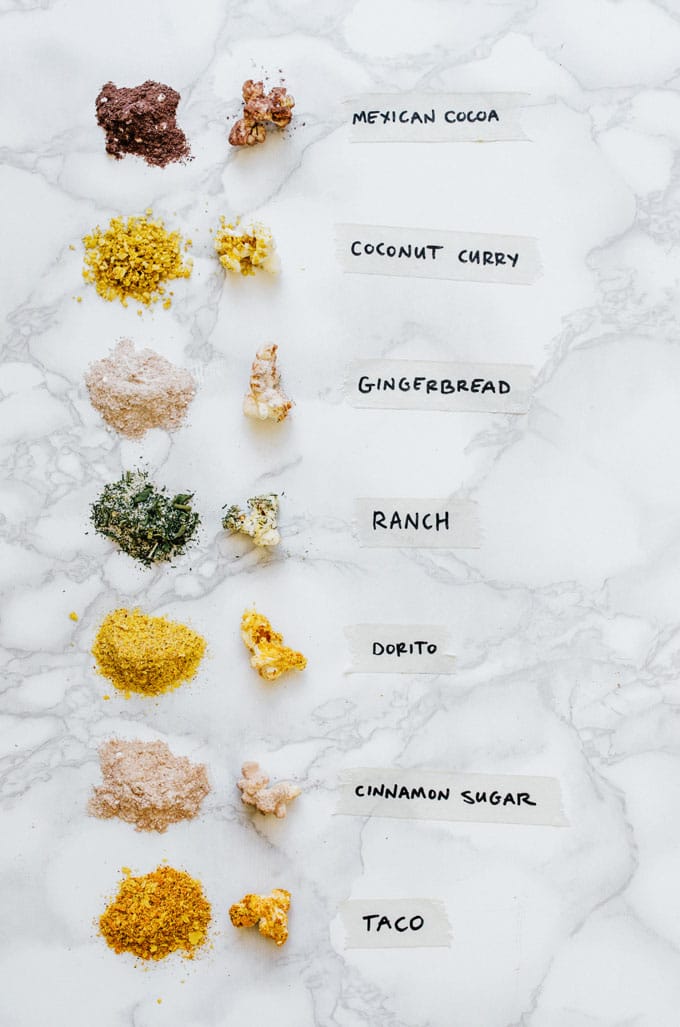 Homemade popcorn seasoning in 7 flavors with labels on a marble background