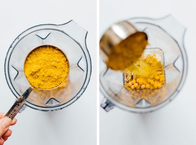 Pouring a measuring cup filled with nutritional yeast into a blender