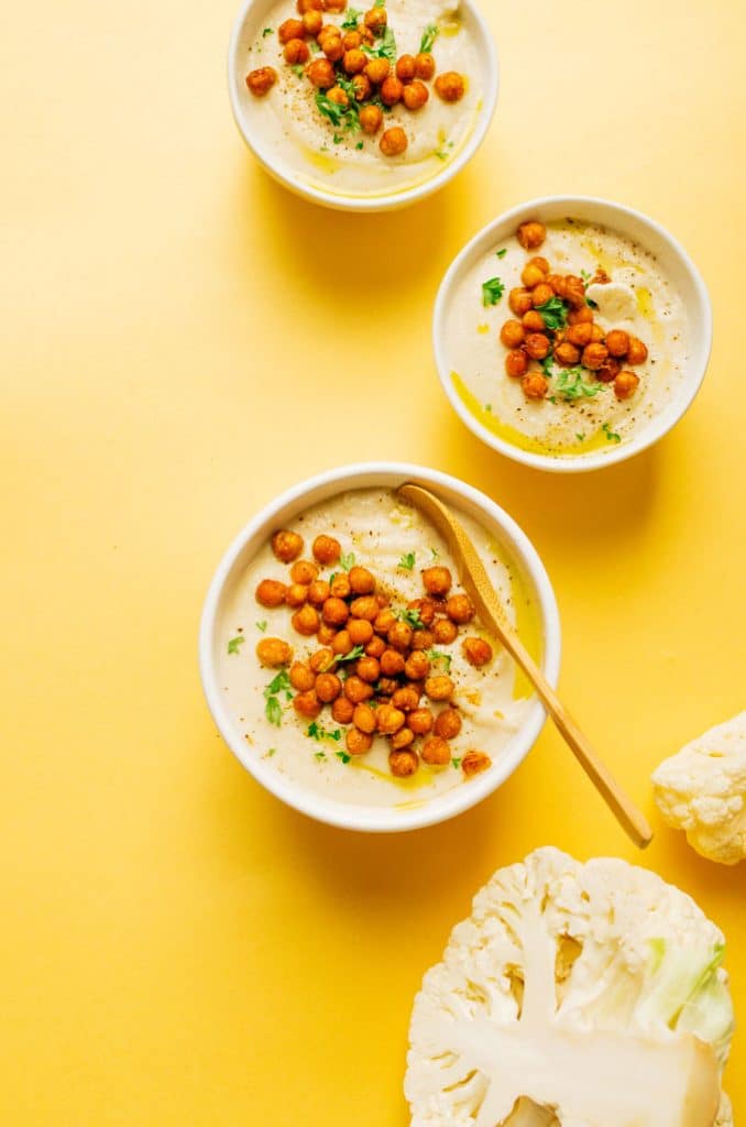 Creamy cauliflower soup on a bowl with crispy chickpeas on top