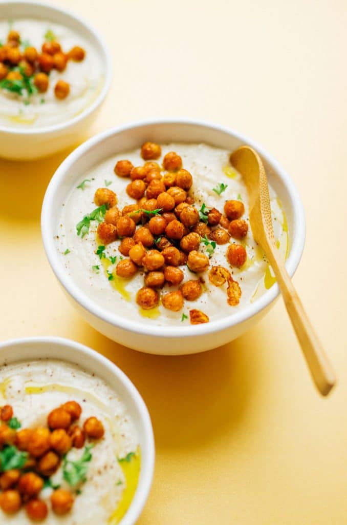 Creamy cauliflower soup on a bowl with crispy chickpeas on top