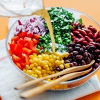 This easy Bean Salad recipe is famous in our house, and for good reason! Quick to make, packed with flavor, and perfect for bringing to potlucks!