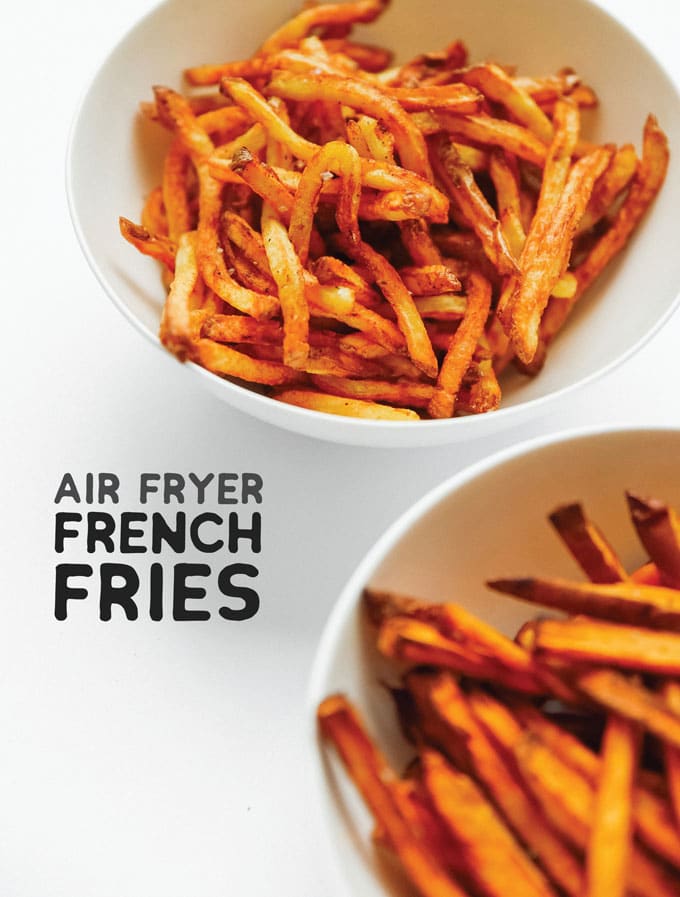 Air fryer French fries on a white background - The ultimate guide on how to cook air fryer potatoes! How to make roasted potatoes, homemade French fries, and potato chips in your air fryer, using both white potatoes and sweet potatoes.