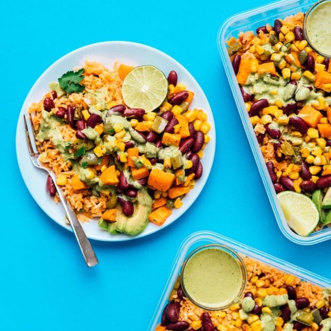 Meal prep on a blue background - Serving up some easy vegetarian meal prep today in the form of roasted veggies with Spanish rice, tossed in a creamy cilantro dressing!