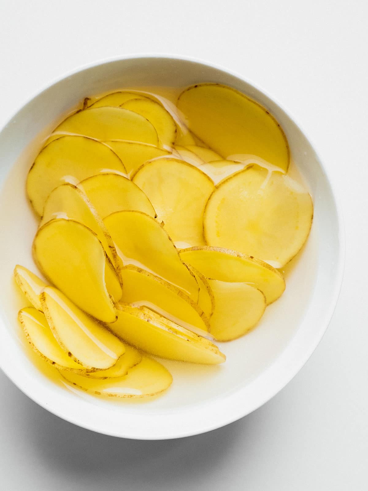 Soaking potato chips before cooking.