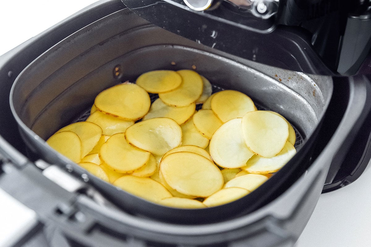 Uncooked potato chips in an air fryer