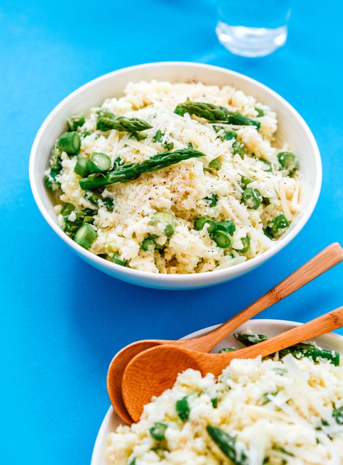 Cauliflower risotto recipe in a bowl on a blue background - This Cauliflower Risotto recipe is a low carb, keto-friendly twist on traditional risotto. Creamy and cheesy, without all the carbs!
