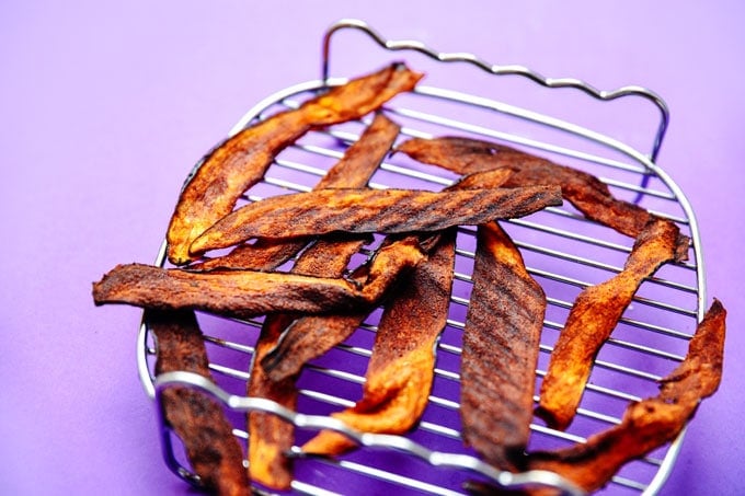 Vegan eggplant bacon recipe on purple background - This vegan Eggplant Bacon recipe takes all the flavor and crispiness of bacon and packs it into thinly sliced bacon! 