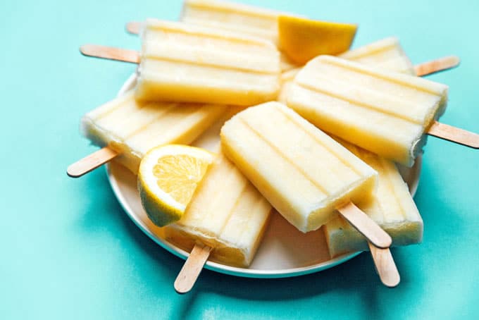 Lemon buttermilk popsicles with ice on a plate
