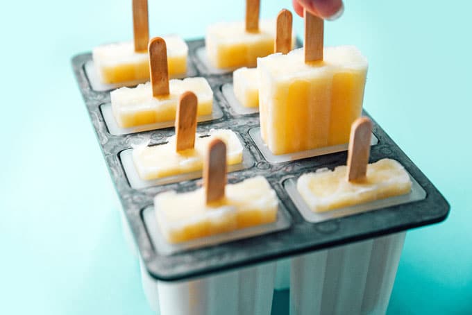 Lemon buttermilk popsicles with ice in a popsicle mold