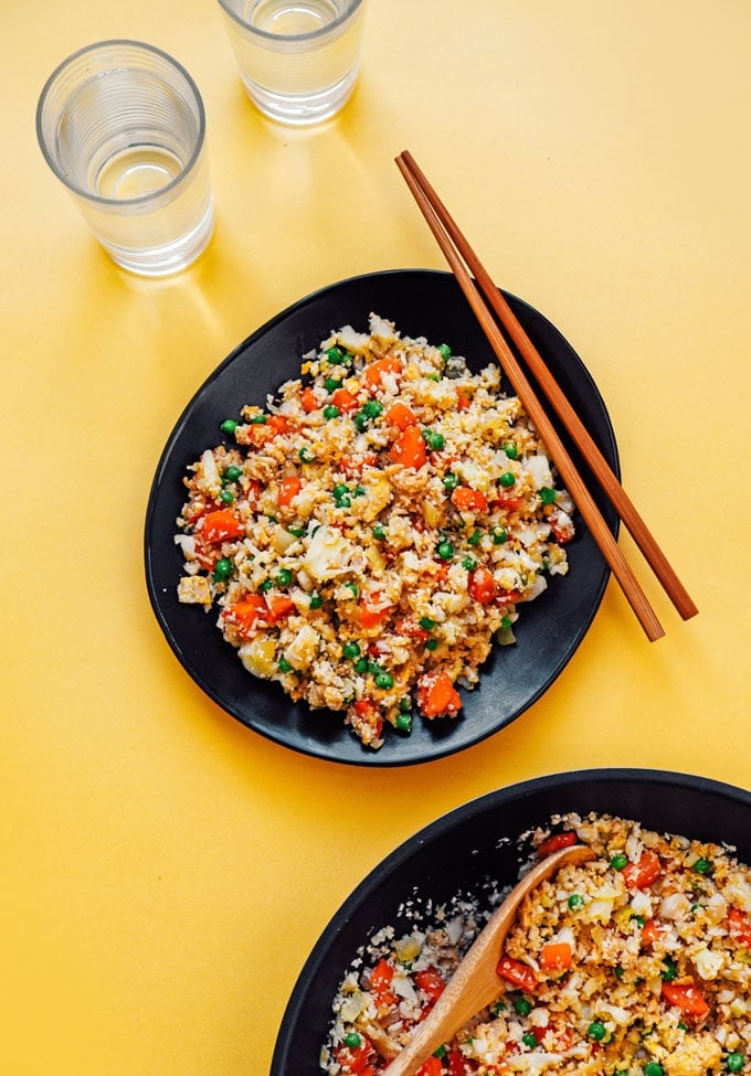 How to make low carb cauliflower fried rice recipe on a black plate with chopsticks