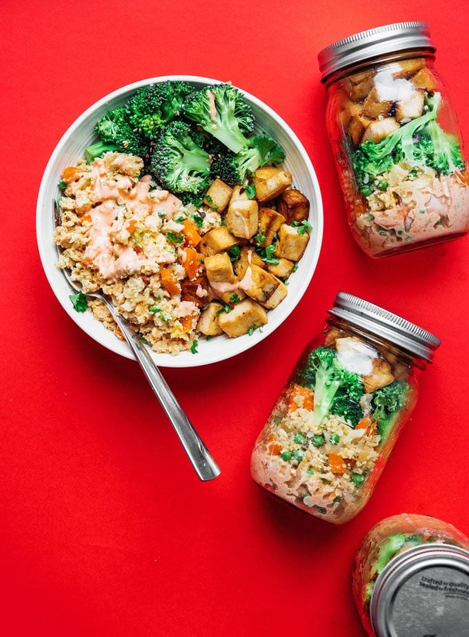 Vegetarian stir fry meal prep recipe idea in mason jars on a red background
