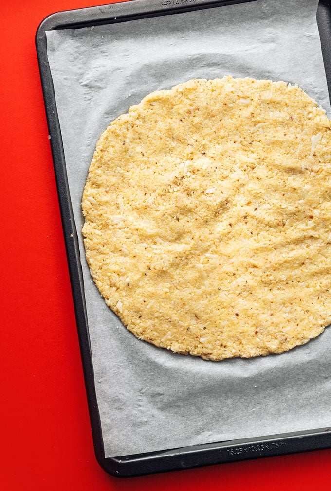 How to make cauliflower pizza crust recipe with pizza on red background