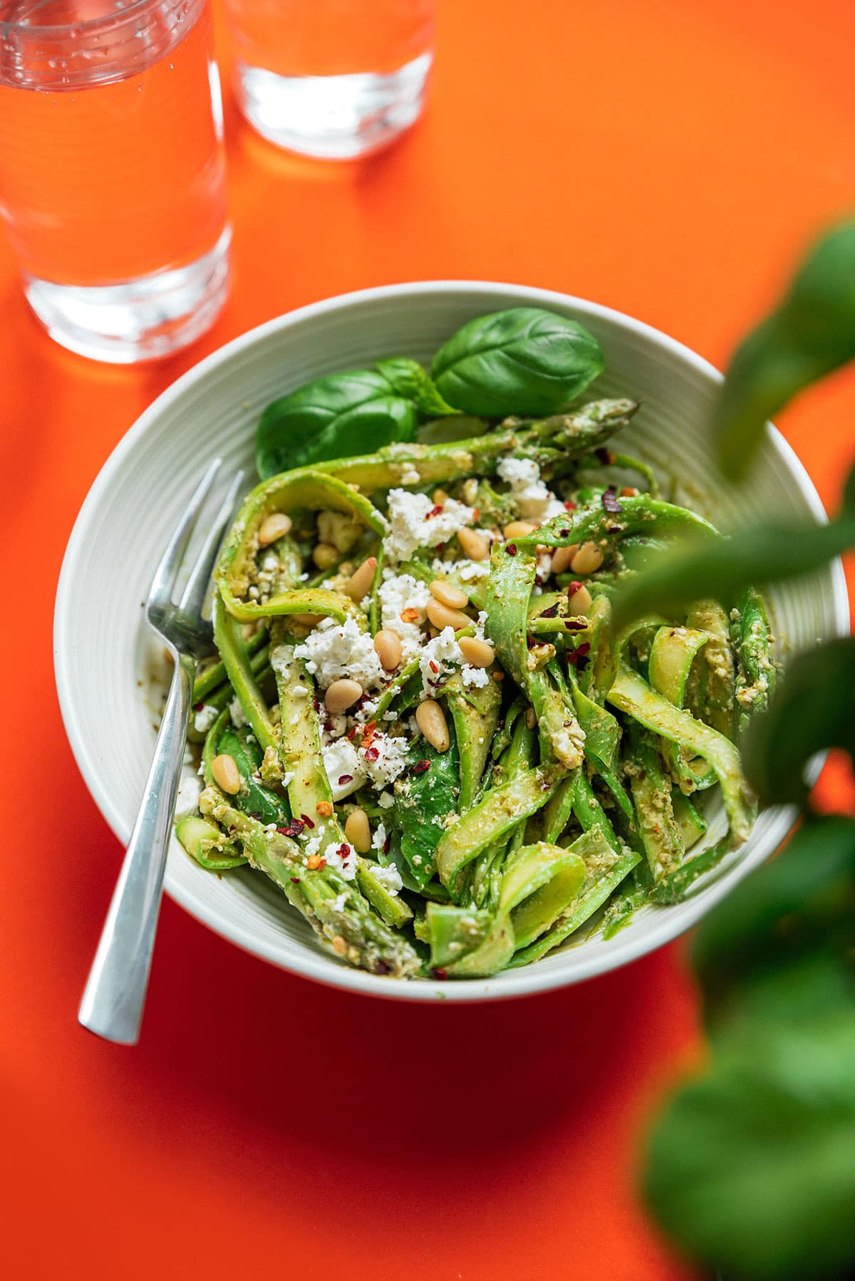 Asparagus noodles in a bowl with pesto.