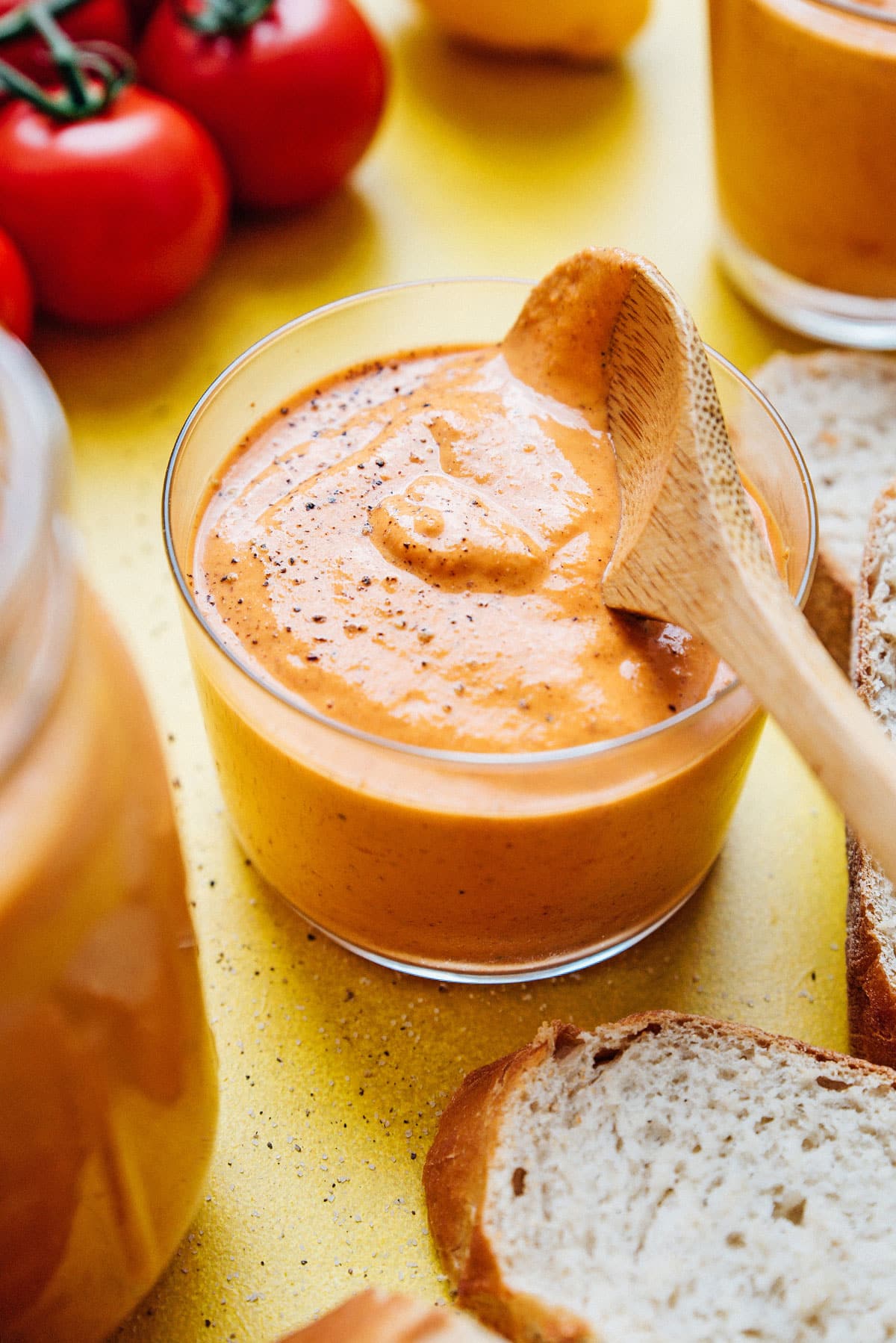 Romesco sauce recipe in a jar with a spoon.