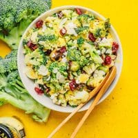 Broccoli salad in a bowl on a yellow background
