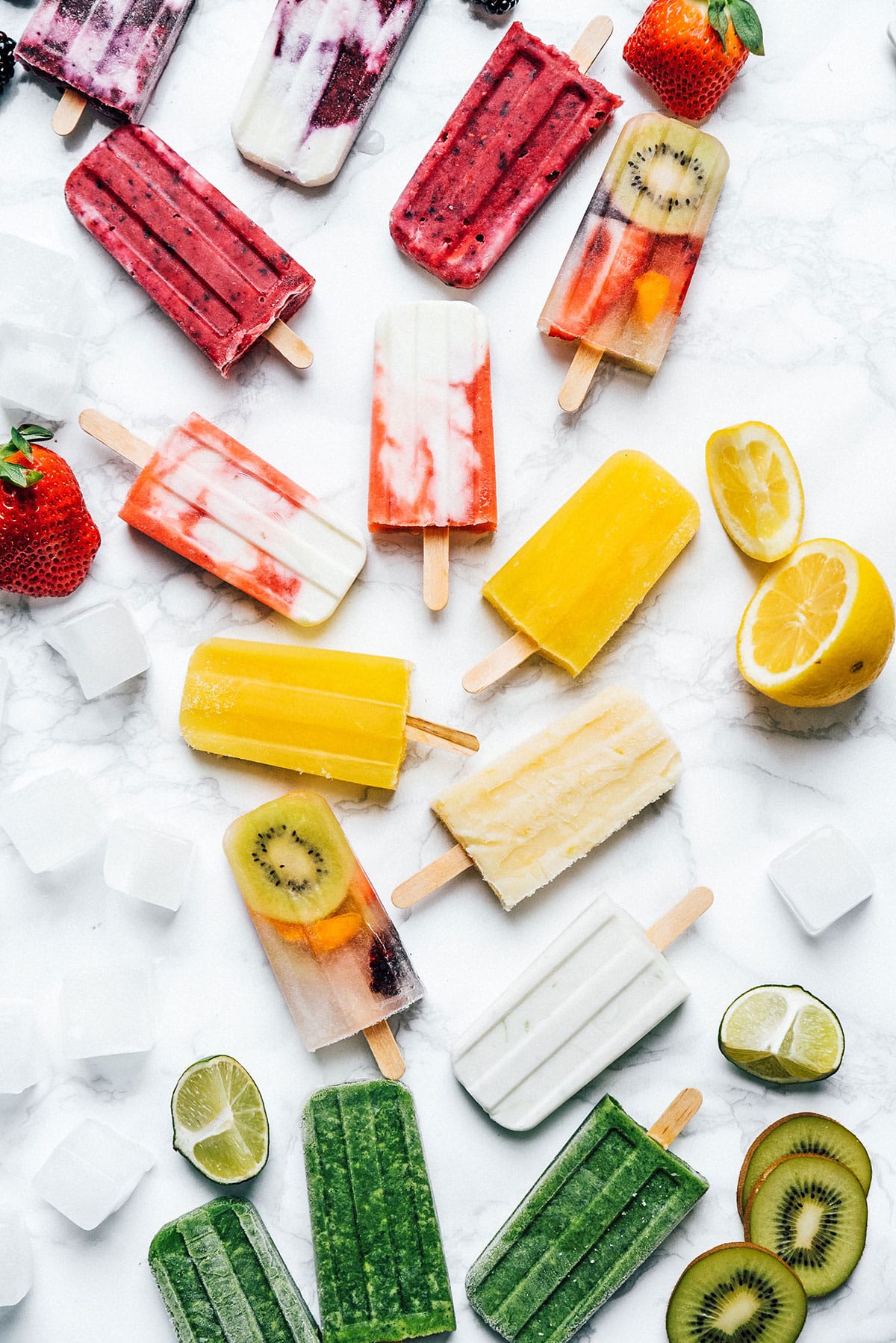 Colorful popsicles on a marble background.