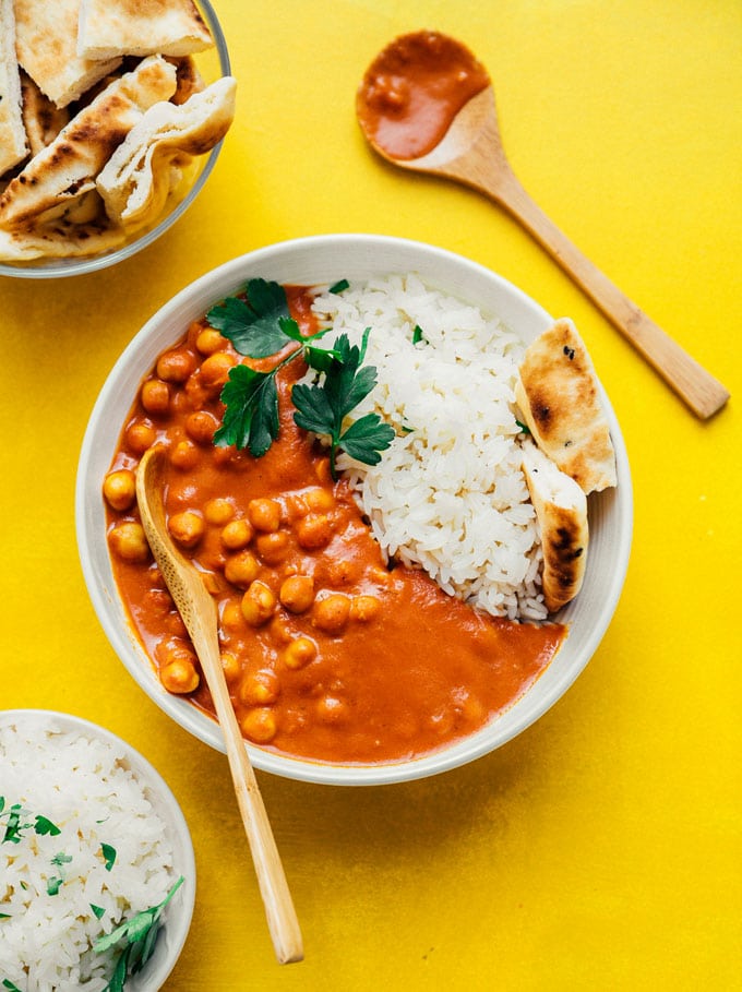 Vegetarian tikka masala with naan and rice in a white bowl
