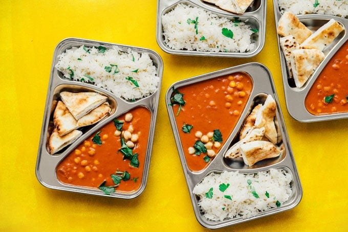 Vegan tikka masala with naan and rice in meal prep containers