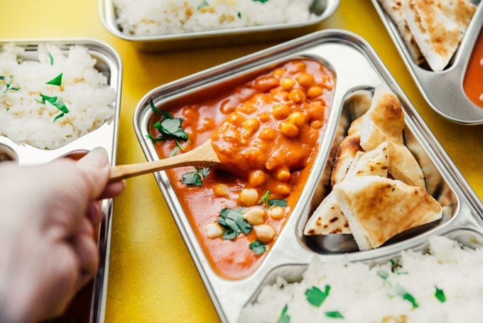 Chickpea tikka masala with naan and rice in meal prep containers