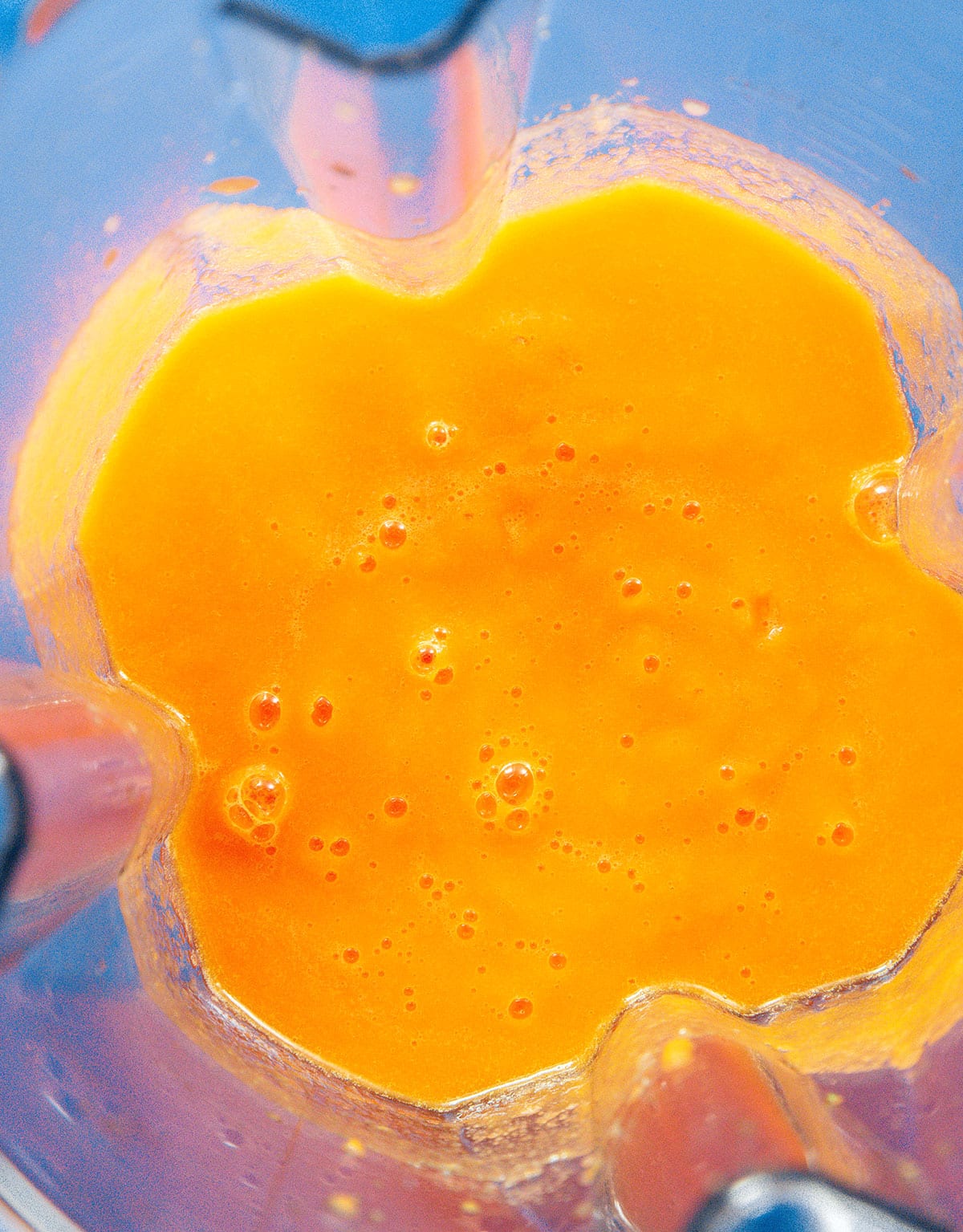 Orange liquid in a blender.