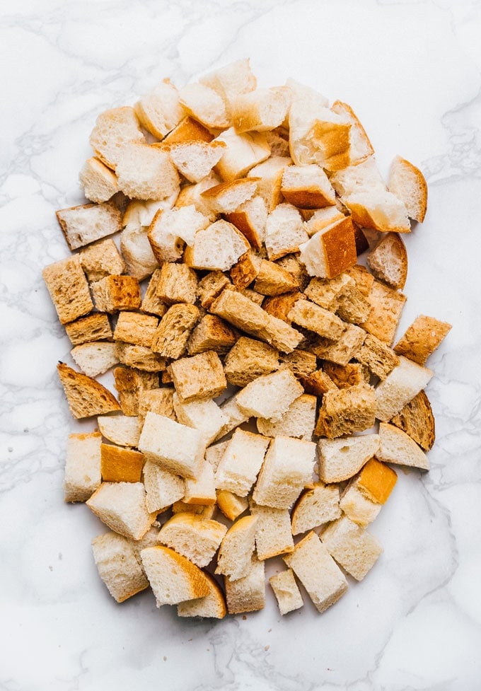 Cut up bread on a marble table for croutons