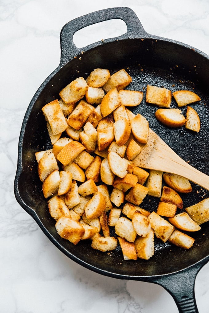 Making homemade croutons in a cast iron skillet