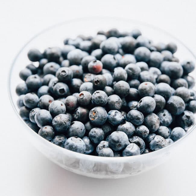 Closeup photo of blueberries in a bowl.