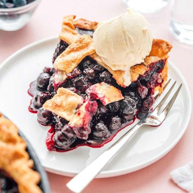 Slice of blueberry pie with ice cream