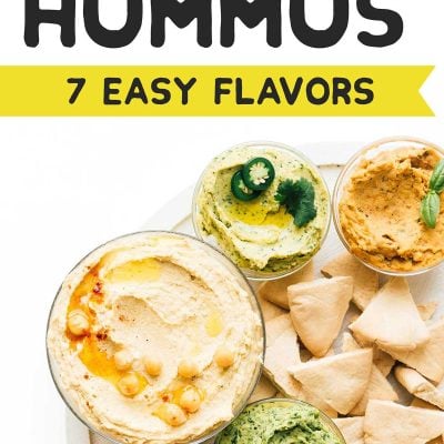 Different flavors of homemade hummus in bowls on a white background